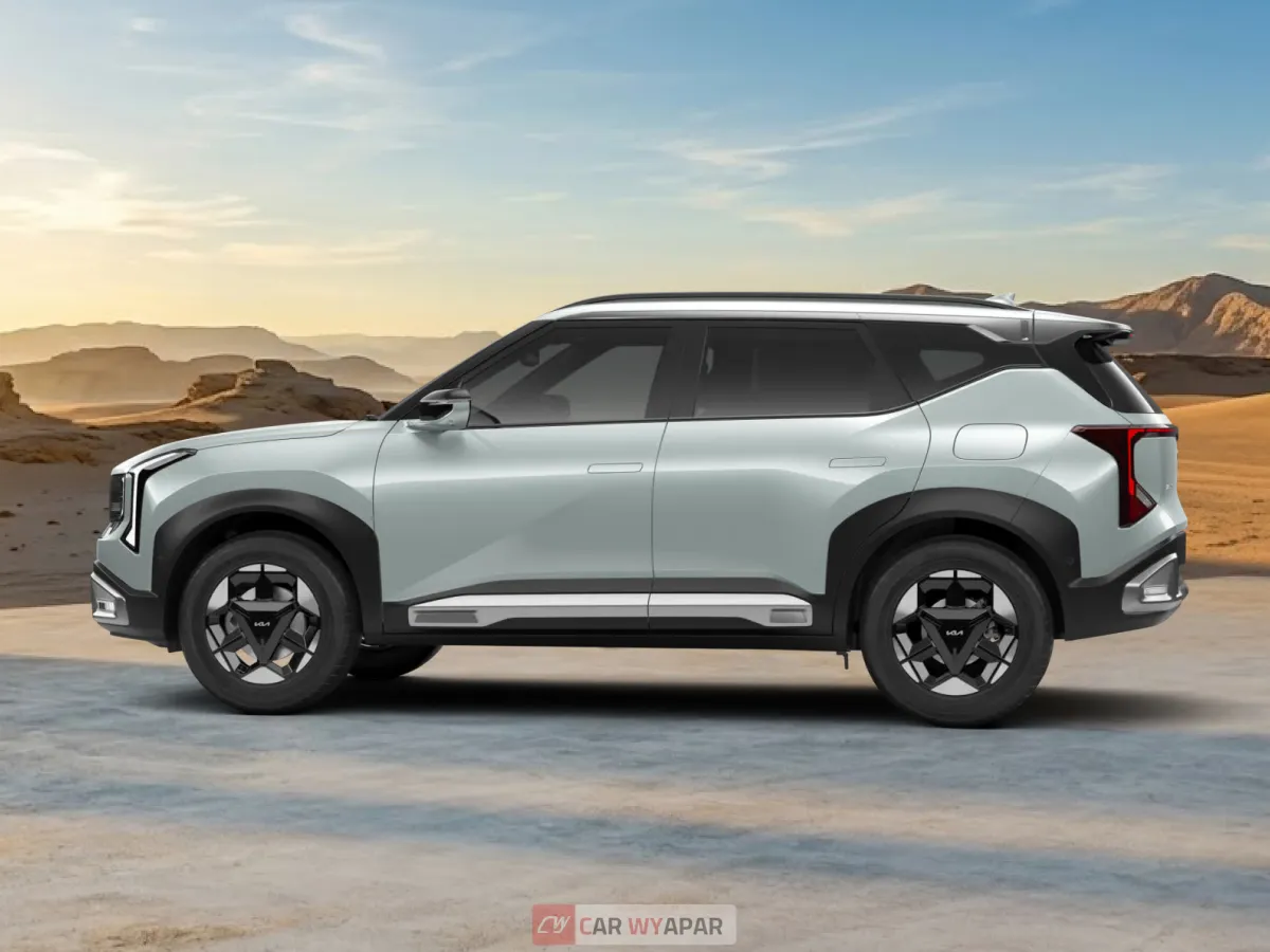 Full side profile of a light silver/mint Kia Seltos HTX parked in a desert landscape, showcasing the alloy wheels and silver roof rails.